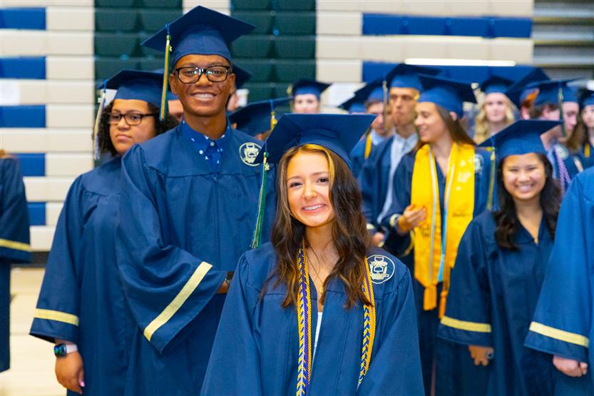 Students wearing blue graduation robes